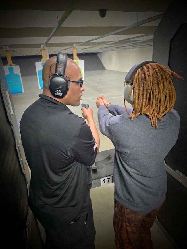 Gideon Training Solutions certified instructor providing private one-on-one handgun instruction to a student at a DFW area shooting range. Both instructor and student wear hearing protection during live-fire training session. Private firearms instruction tailored to individual skill level and goals available in Dallas, Fort Worth, Mansfield, Arlington, and all North Texas cities.